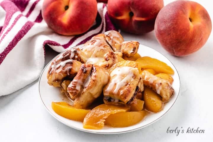 The cinnamon roll peach cobbler in a small plate.