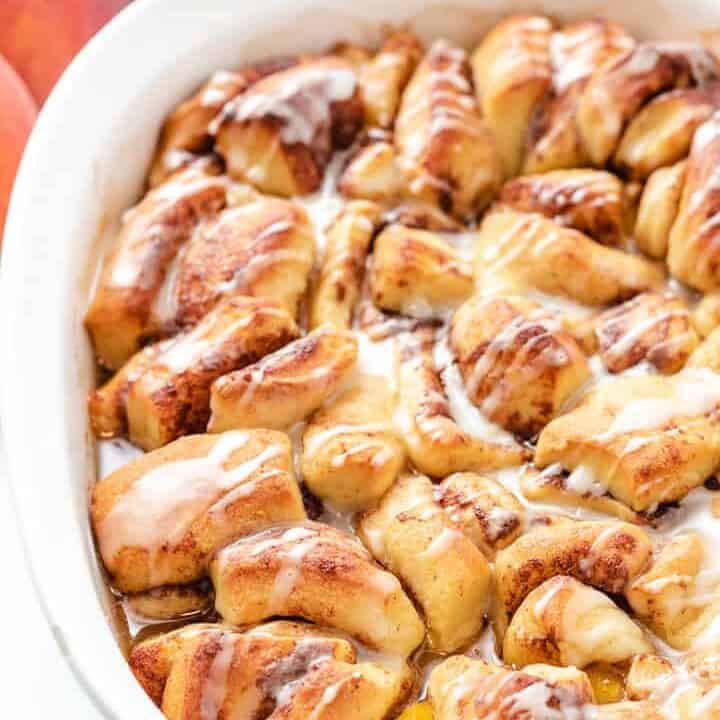 Cinnamon Roll Peach Cobbler An up-close view of the baked cobbler in a baking dish.