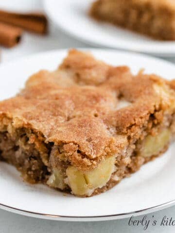 A slice of fresh apple cake on a plate.