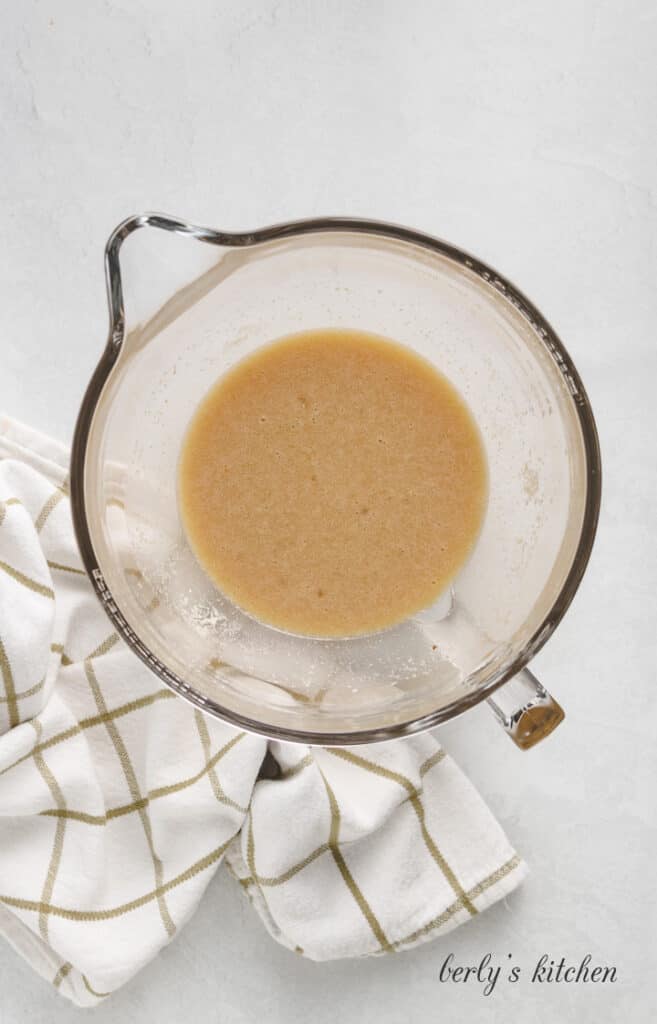 Pineapple juice and other ingredients mixed in a glass bowl.