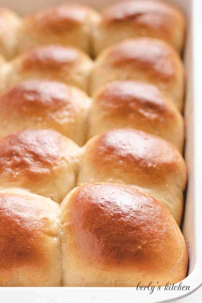 A close-up of the baked rolls topped with butter.