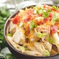 Brown bowl with chicken pasta.