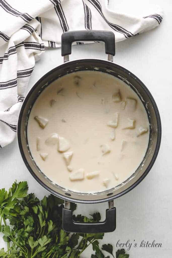 Diced potatoes added to the soup broth.