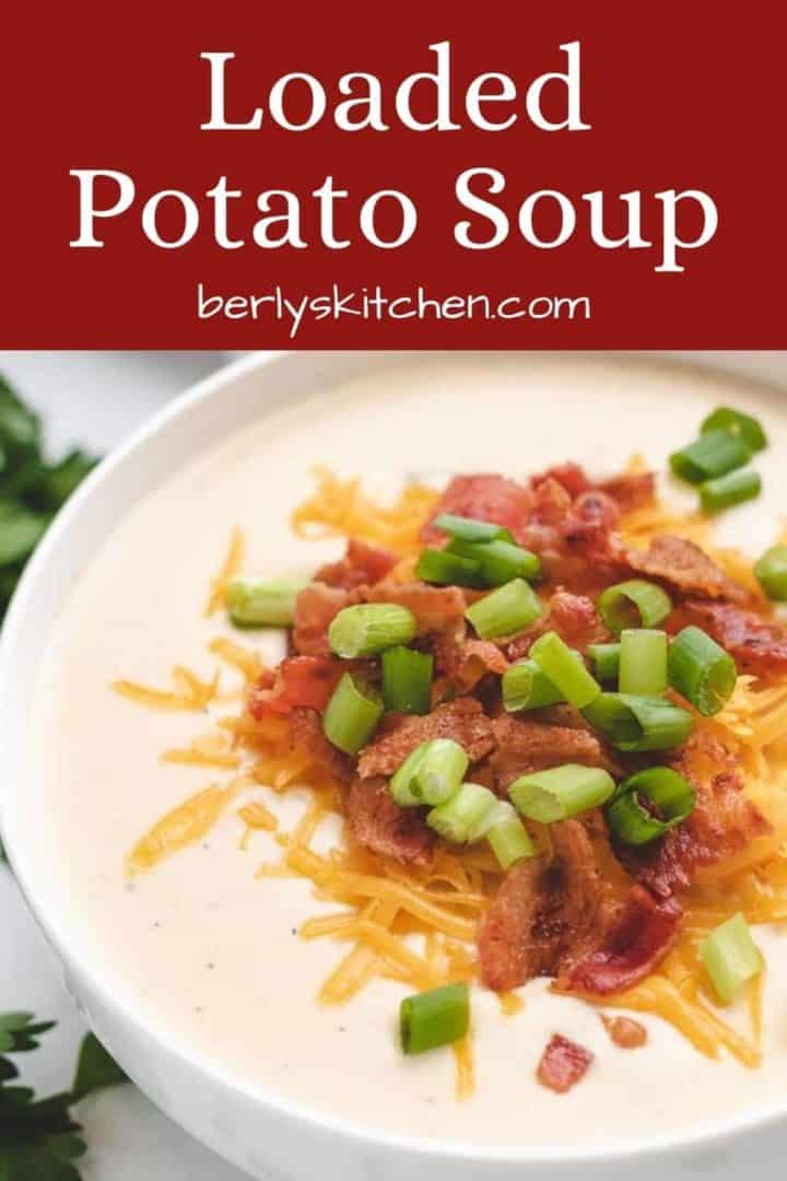 A bowl of loaded potato soup with bacon and cheddar.