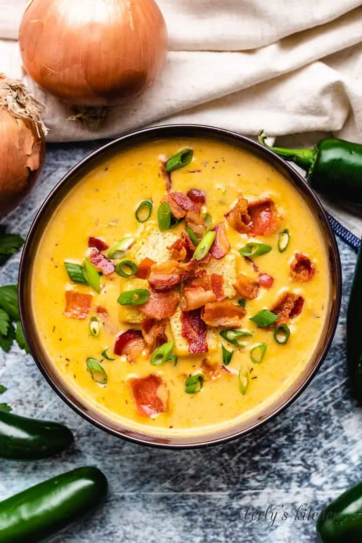 Creamy JalapeÑO Beer Cheese Soup The finished soup served in a brown bowl.