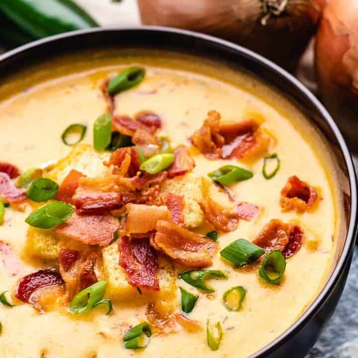Diced green onions and crispy bacon atop the soup.