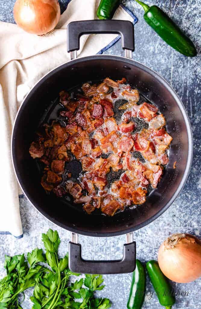Smoky bacon cooking in a stock pot.