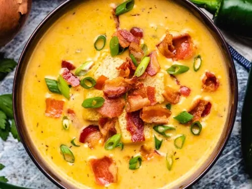 An aerial view of the beer cheese soup in a bowl.