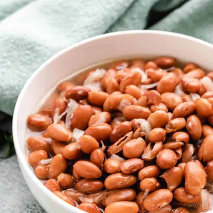 Ham and beans served in simple white bowl.
