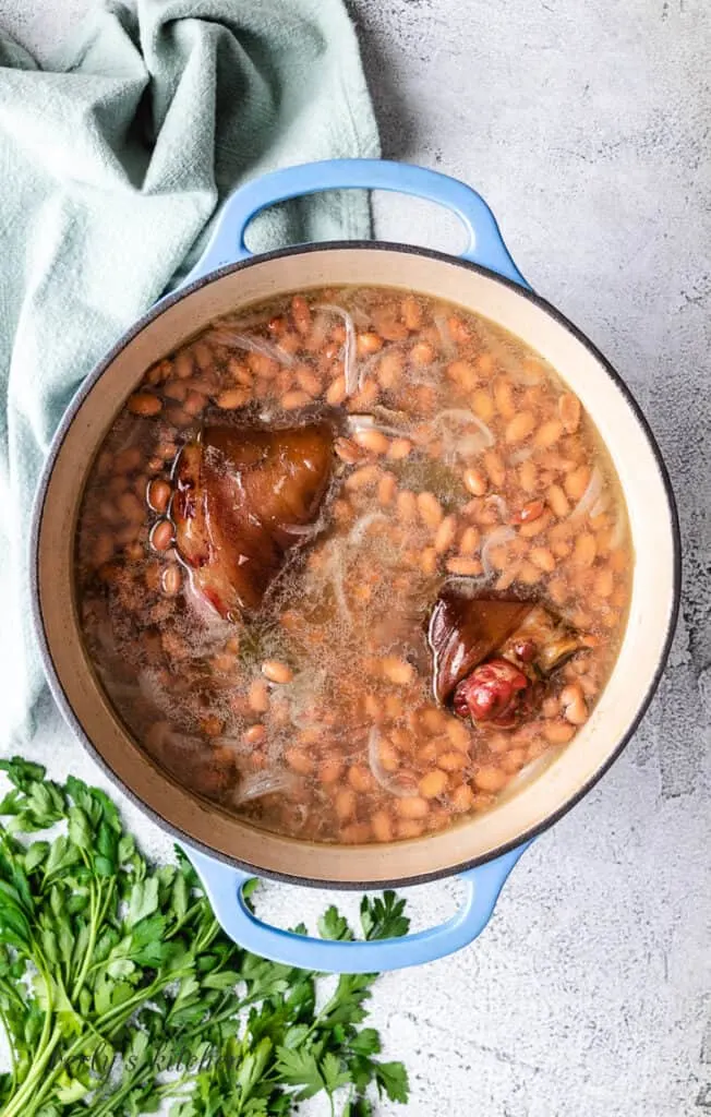 Canned pinto beans added to the broth.