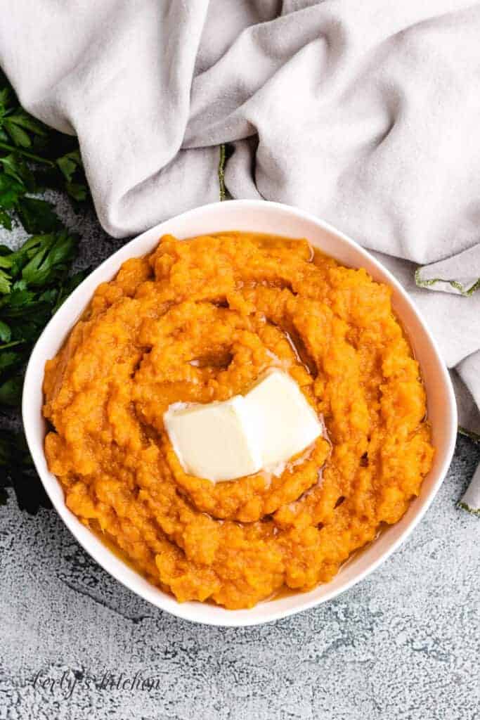 A top-down view of the mashed potatoes with butter.