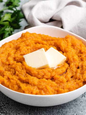 Instant Pot mashed sweet potatoes served with butter.