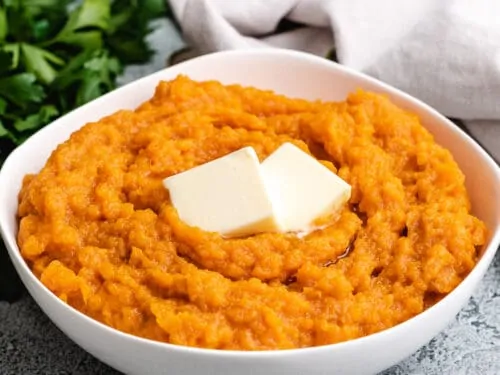 Instant pot mashed sweet potatoes served with butter.