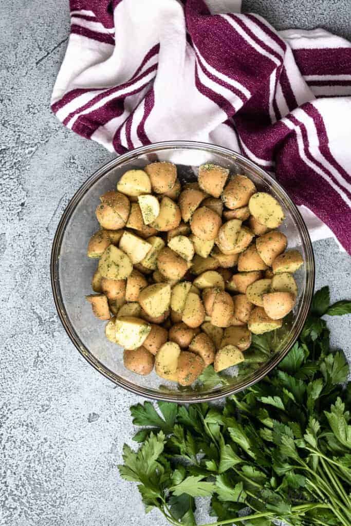 Halved potatoes tossed with ranch seasoning.