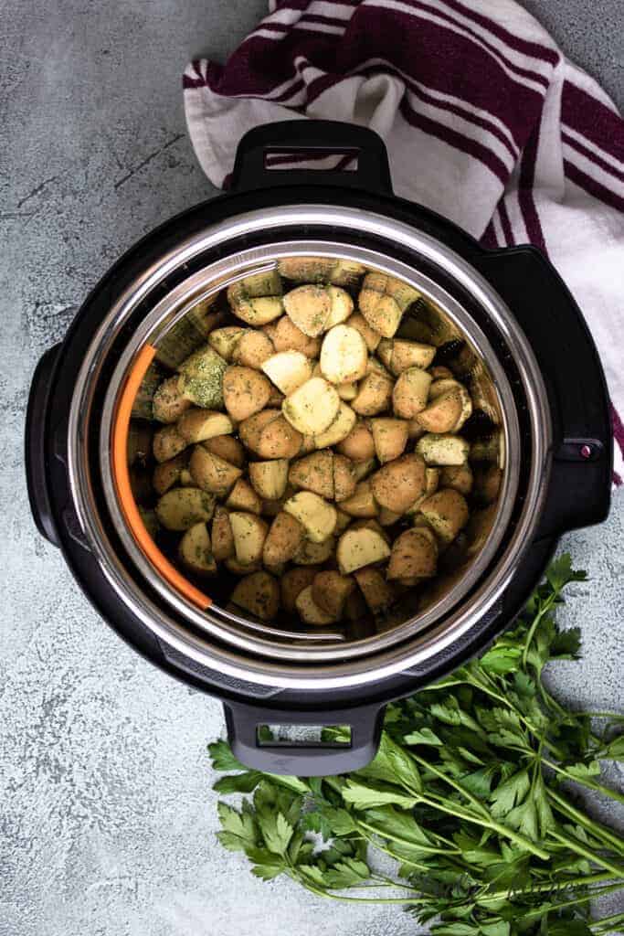 The taters, steamer basket, and liner inside the machine.