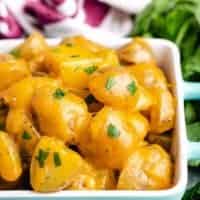 A close-up view of the cheesy potatoes with green onions.