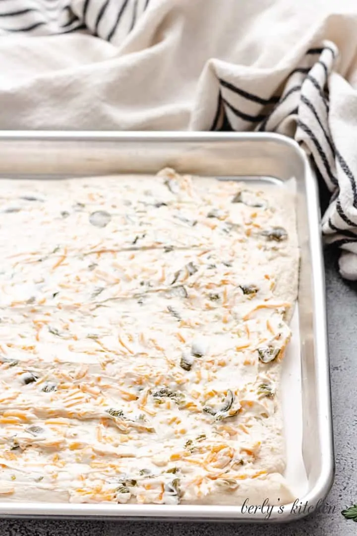 The cream cheese filling spread out onto the dough.