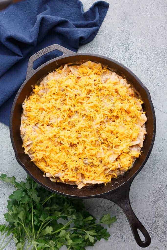 Shredded cheese added to the skillet.