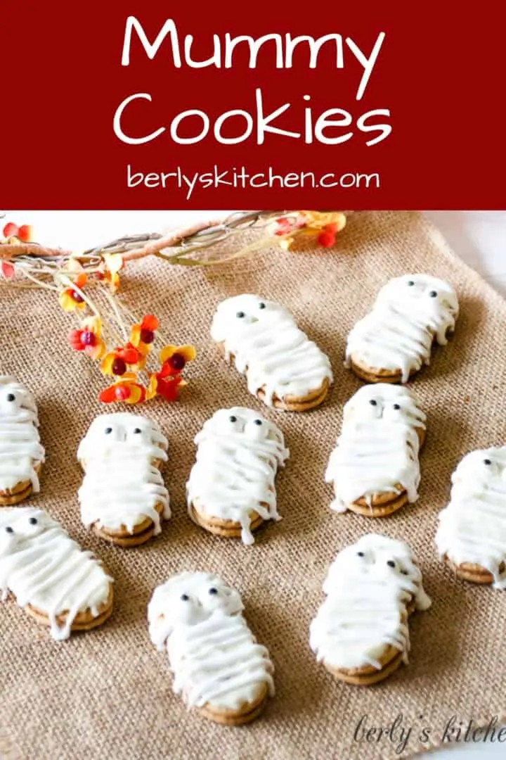 Nutter Butter mummy cookies on a sheet of burlap.