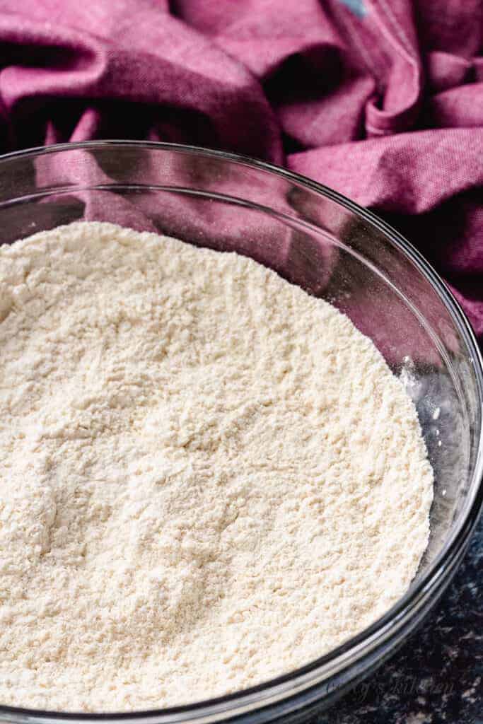 Flour, salt, and baking powder mixed in a bowl.