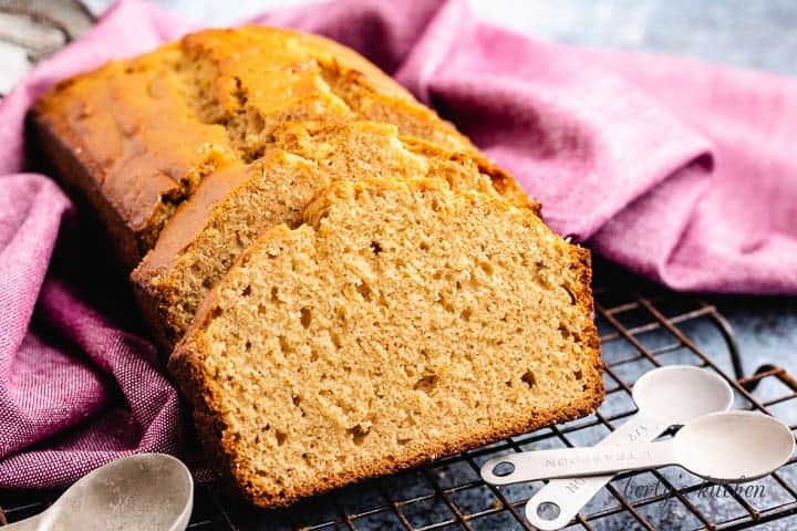 Freshly baked and sliced peanut butter bread on a rack.