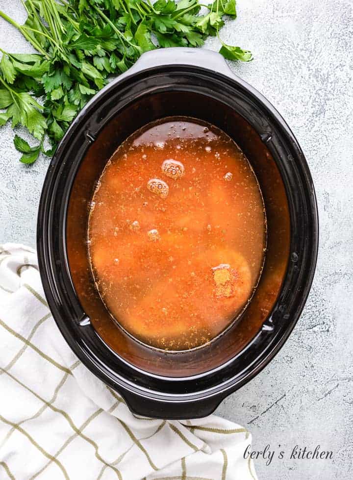 Chicken broth added to the cooker.