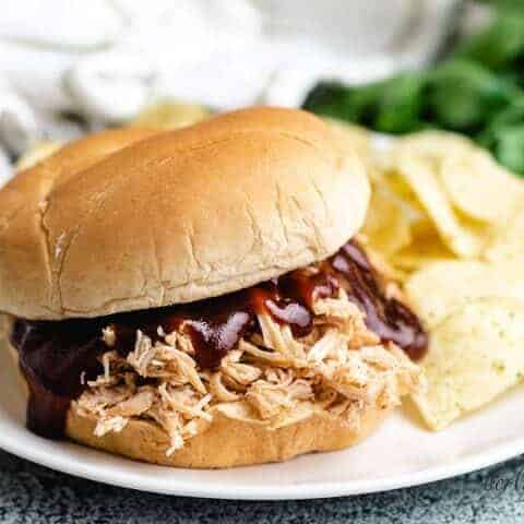 Slow Cooker Bbq Chicken A slow cooker bbq chicken sandwich on a plate.
