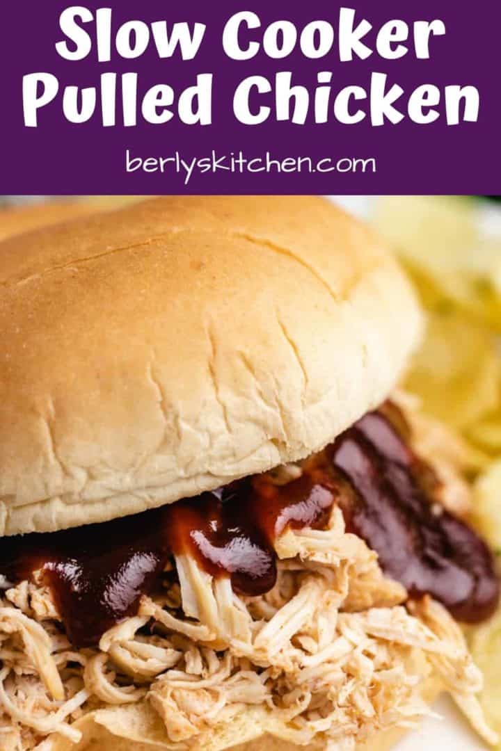 Slow cooker bbq chicken breast on a bun with bbq sauce.