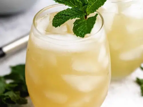 Two bourbon smash cocktails garnished with mint.
