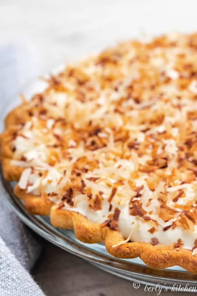 The whipped topping and toasted coconut added to the pie.