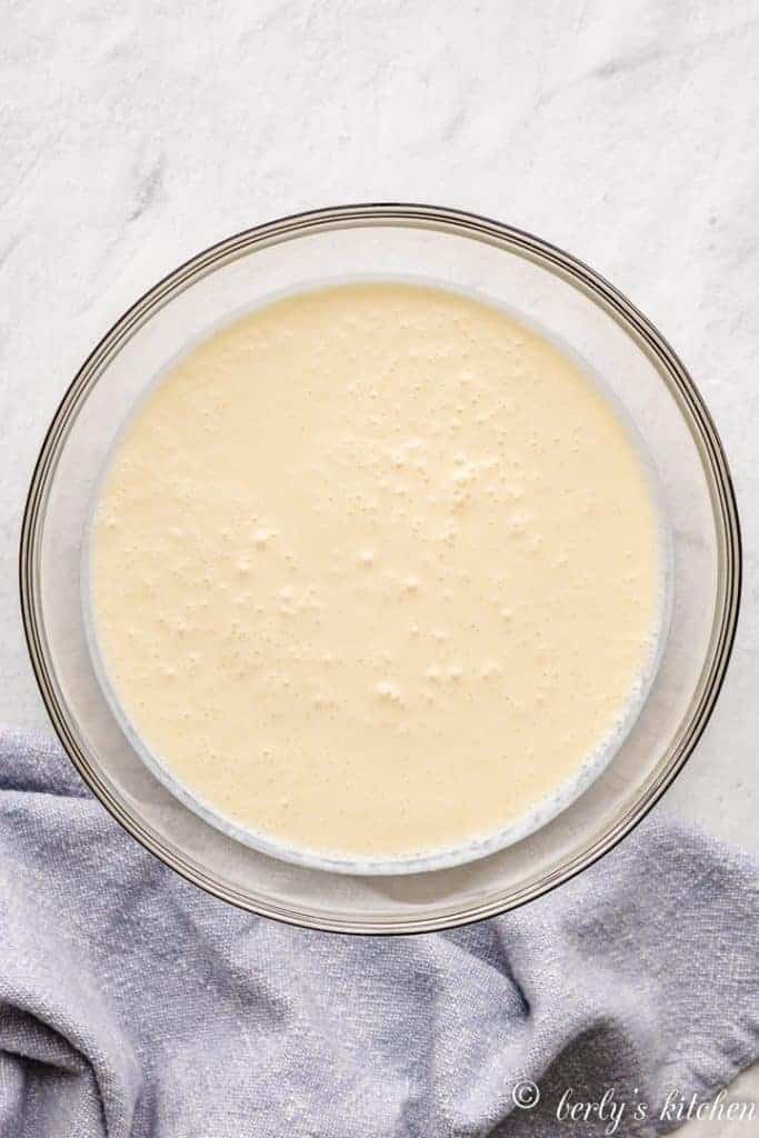 Coconut milk, egg yolks, and other ingredients in a mixing bowl.