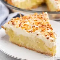 A slice of homemade coconut cream pie on a plate.