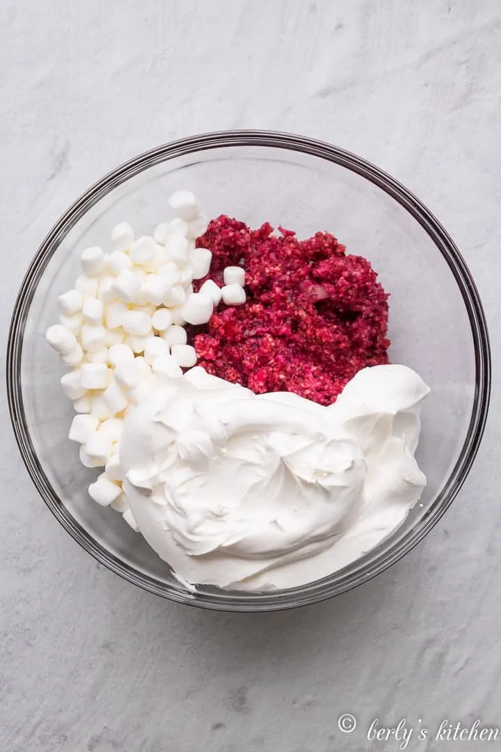 Cranberries, whipped topping, and marshmallows in a bowl.