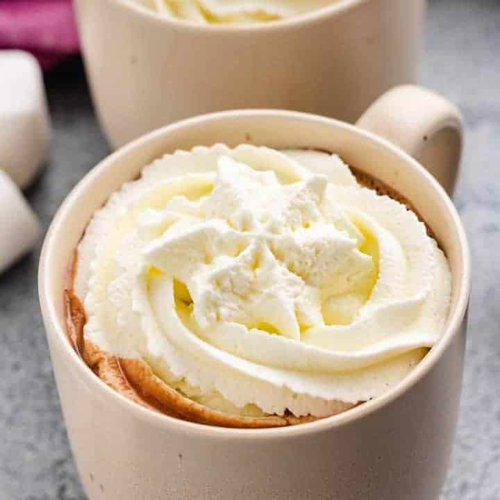Close-up view the cocoa topped with whipped cream.