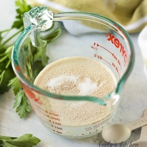 Yeast, sugar, and water in a measuring cup.