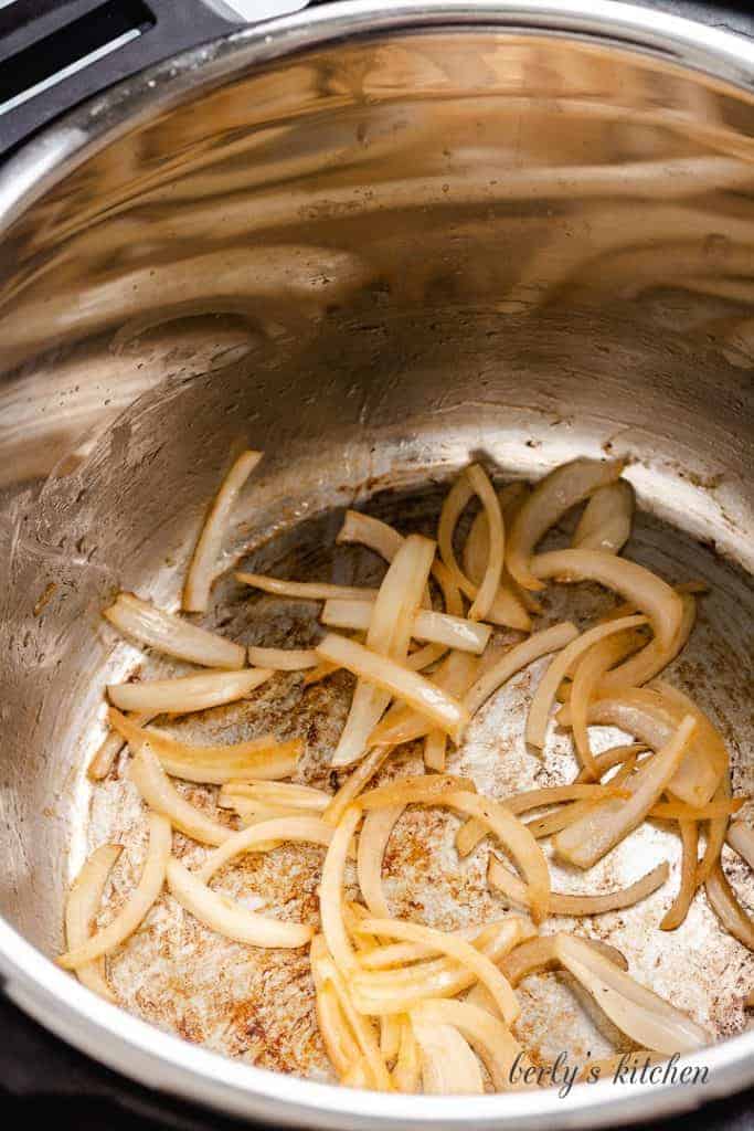 Sliced onions cooking in the pressure cooker.