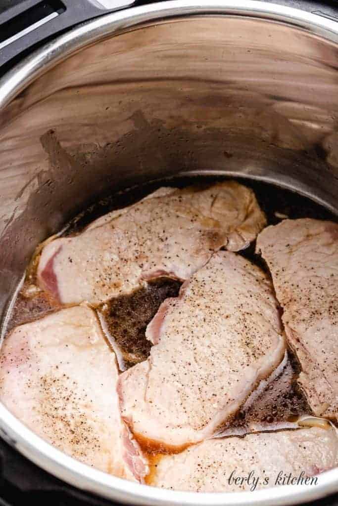 The chops put back into the pot to pressure cook.