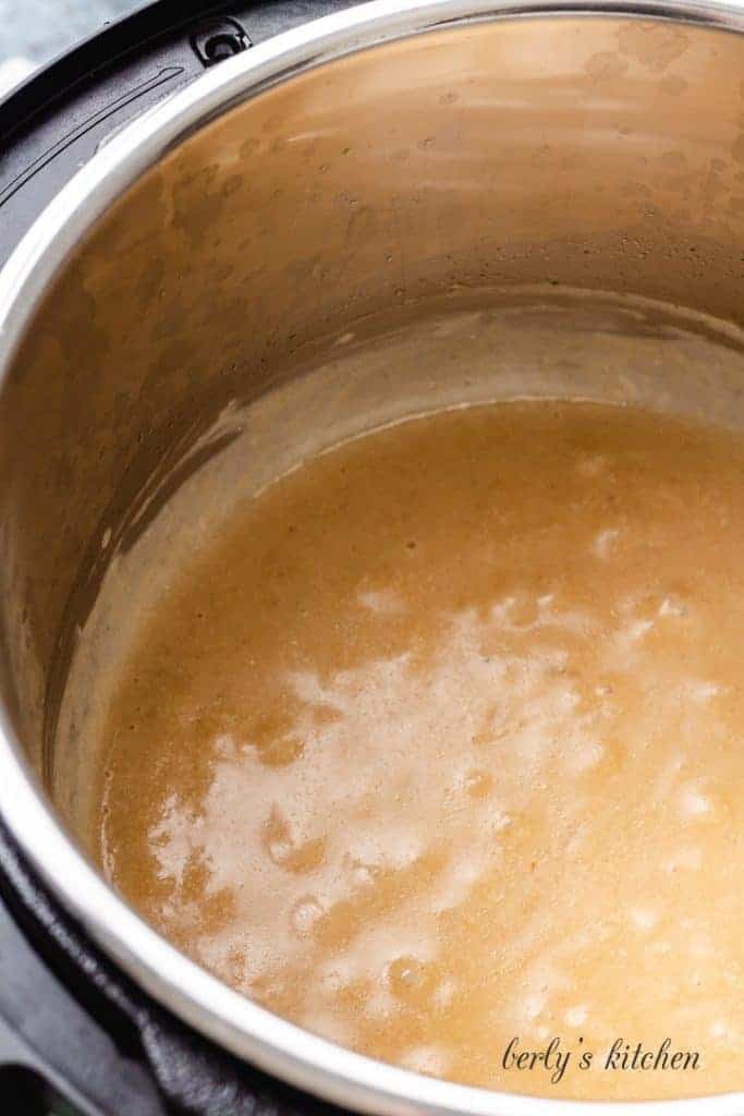 The sour cream gravy simmering in the pot.