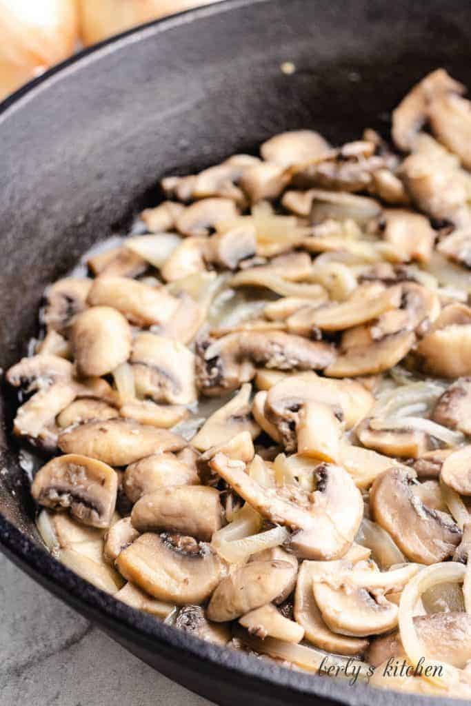 Garlic added to the vegetables cooking in the pan.