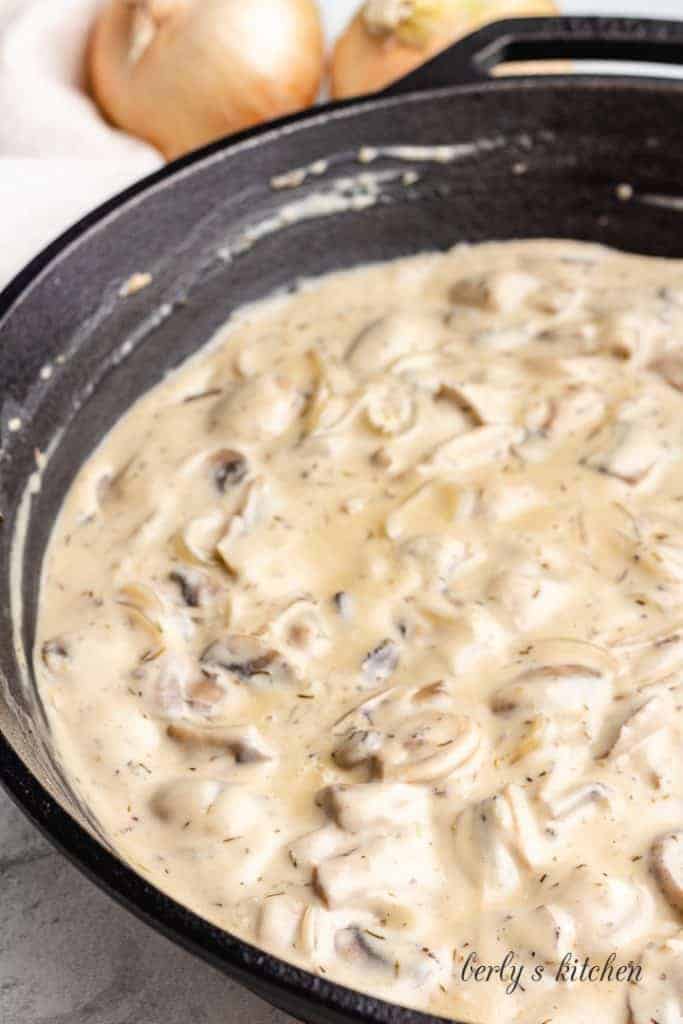 Sour cream added to the skillet to finish the sauce.