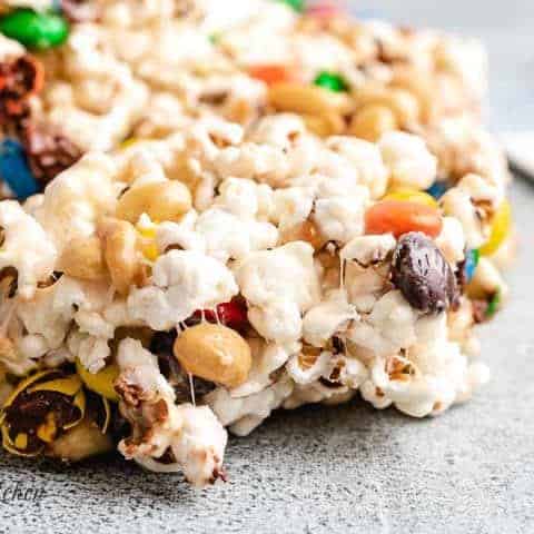 A small bite taken from a gooey popcorn bar.