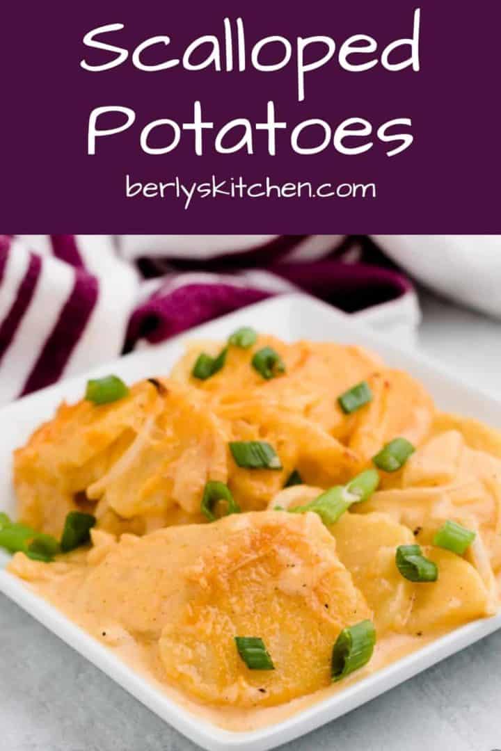 Creamy scalloped potatoes served on a square plate.
