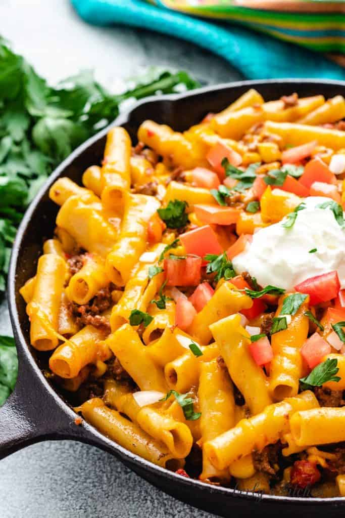 A cast iron skillet filled with the finished pasta.