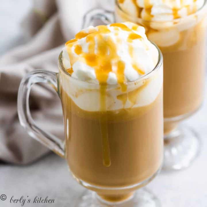 Butterscotch coffee in mugs topped with whipped cream.