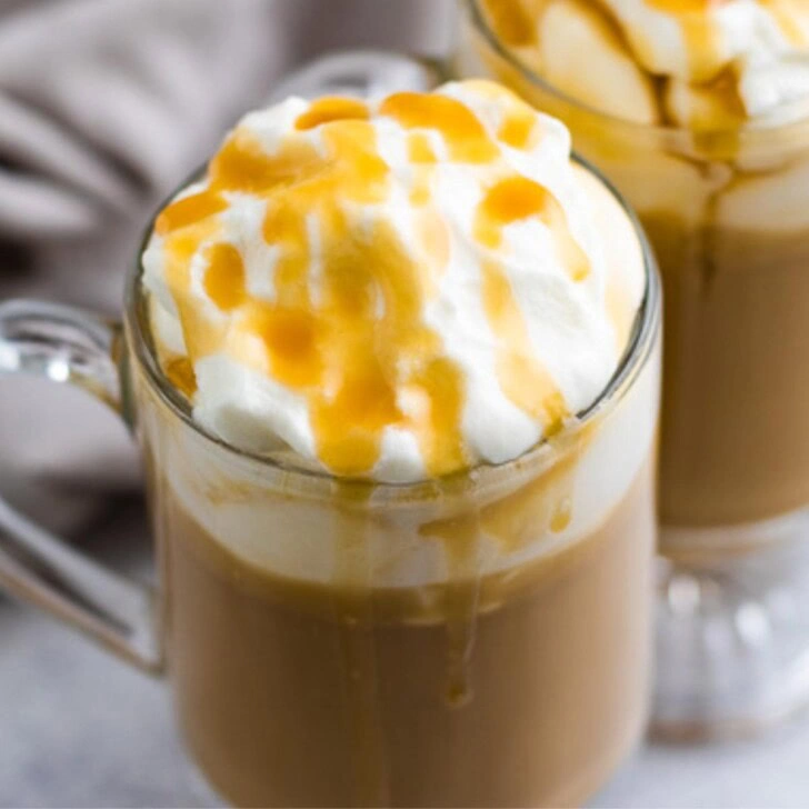 Butterscotch coffee in mugs topped with whipped cream.
