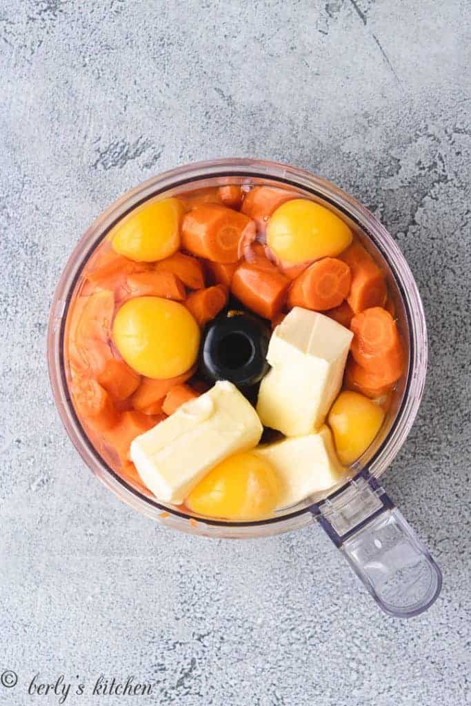 Carrots, eggs, and other ingredients in a food processor.