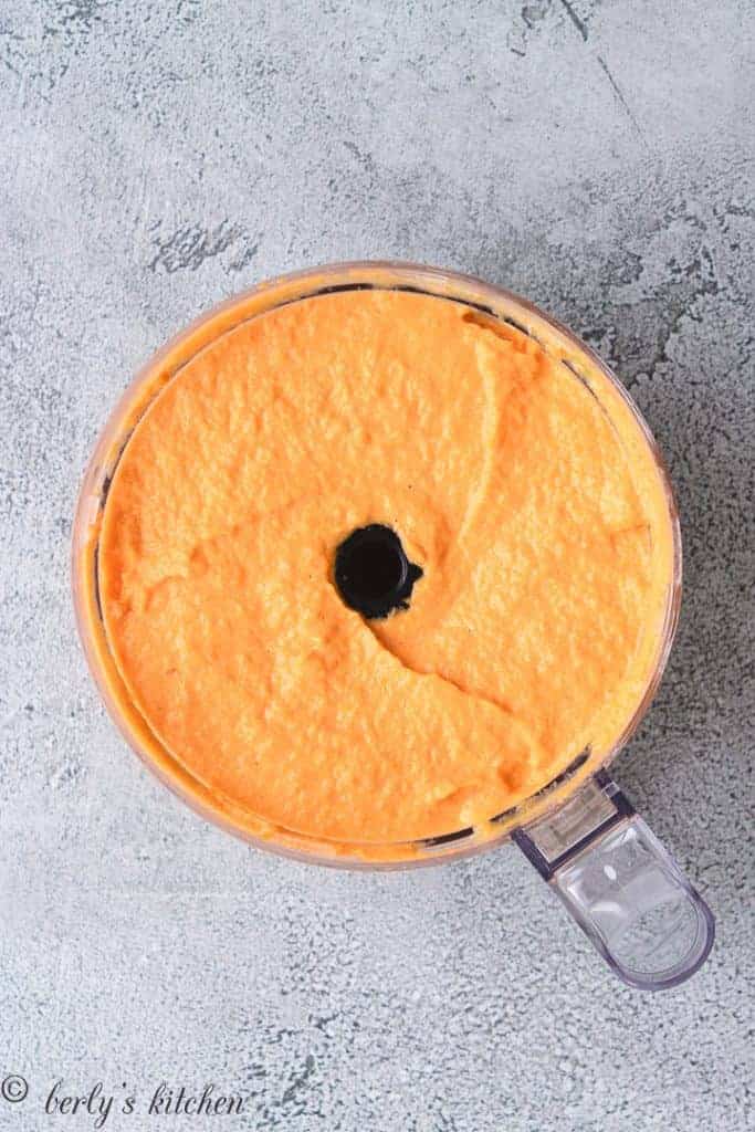 The carrots, eggs, and other ingredients blended in the processor.