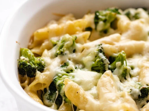 The cooked broccoli cheese pasta bake cooling in a casserole dish.