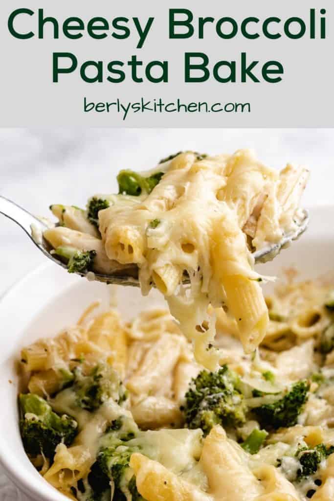 A metal spoon lifting a serving of the broccoli cheese pasta bake.