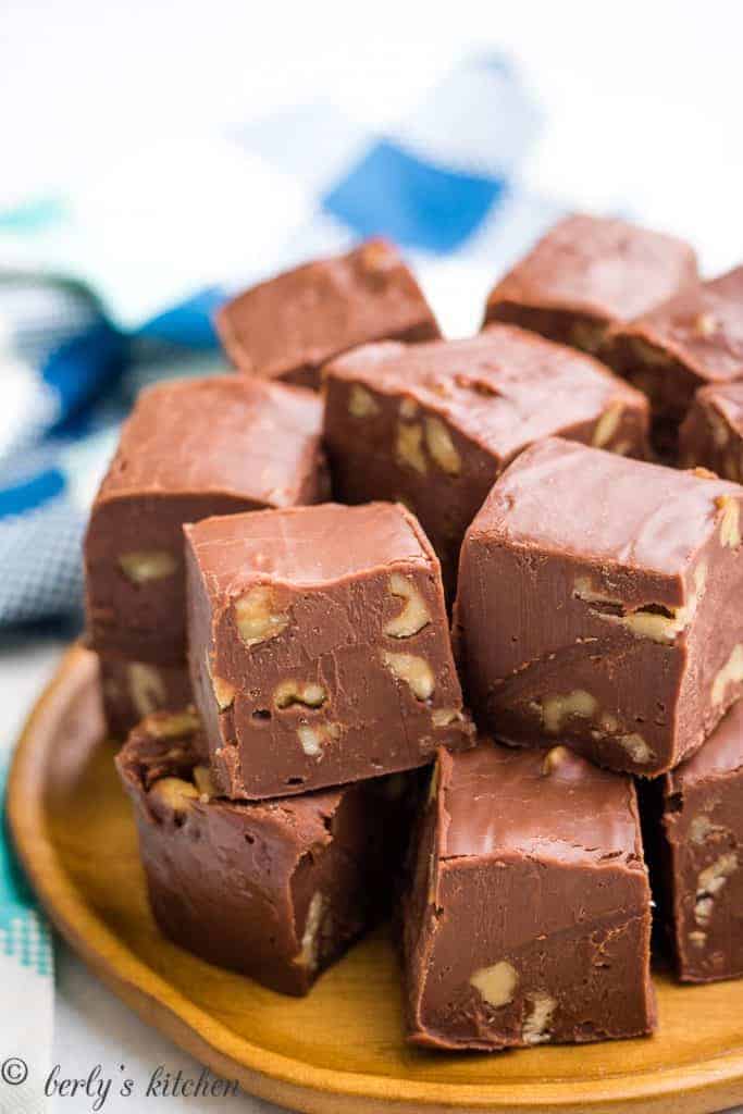 The chocolate fudge cut into cubes on a plate.